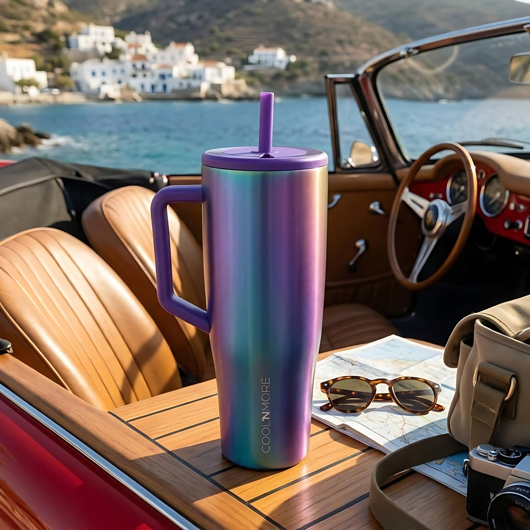 Colorful insulated tumbler with a straw on a car dashboard by the sea. Coolnmore Aurora tumbler θερμος 1200ml με καλαμακι, Vogue series ion plated.