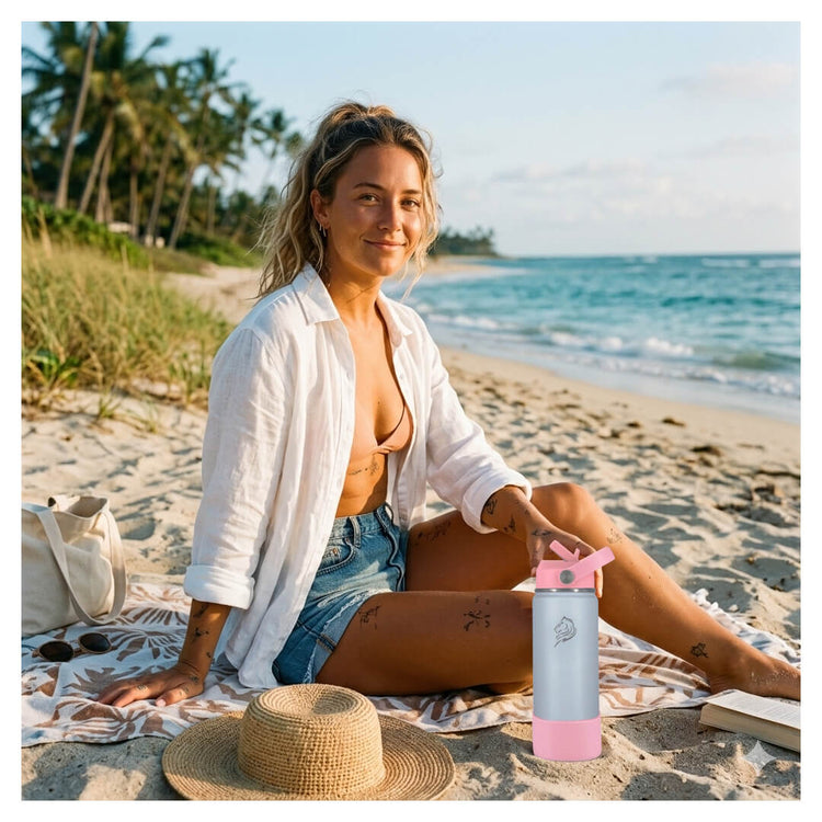 Woman sitting on a beach with a pink water bottle Coolnmore Lush θερμός νερου και καφε 500ml